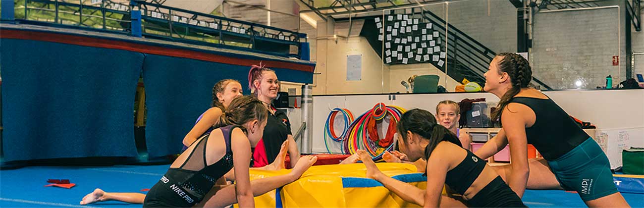 Kids sitting on gymnastics equipment